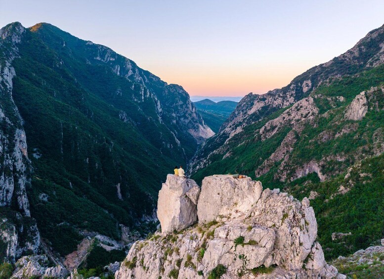A mountainous landscape with a rocky outcrop and a valley. 4