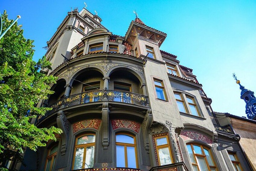 A historic building with ornate balconies and a clock tower. 3