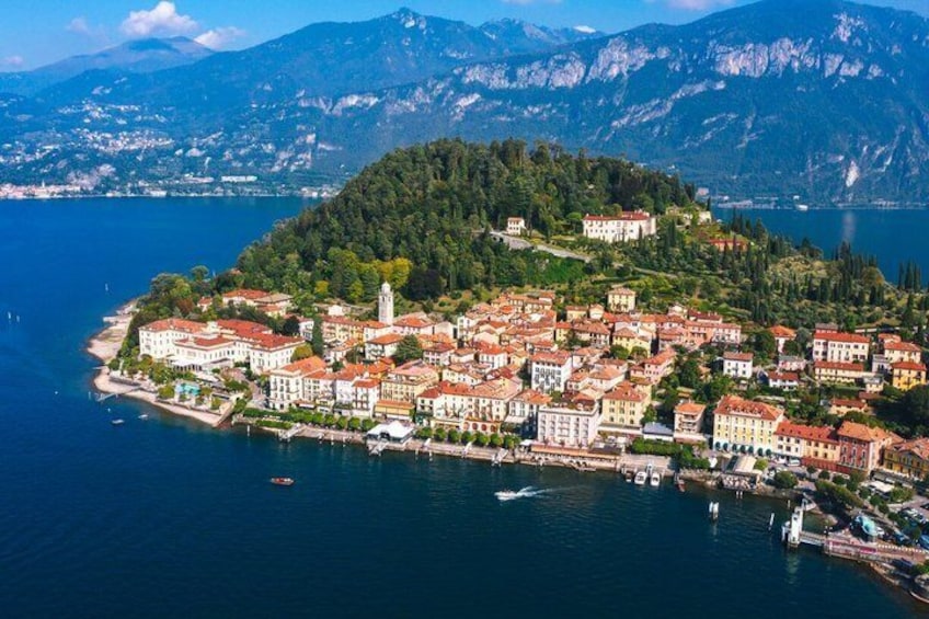A coastal town with buildings, a church, and mountains in the background. 3