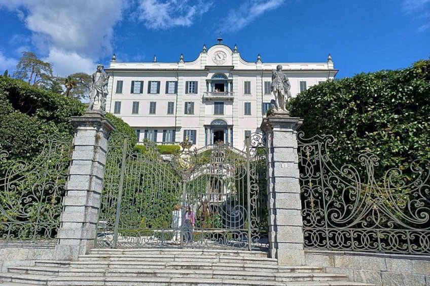 A historic building with ornate iron gates and statues. 2