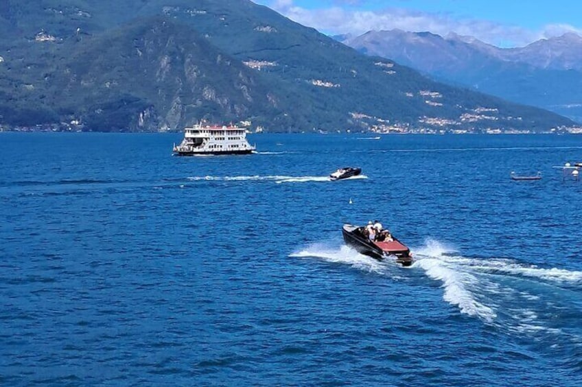 A boat speeding across a lake with mountains in the background. 5