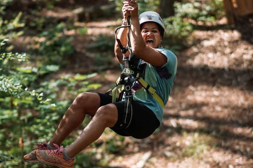 A person zip-lining through a forest. 4