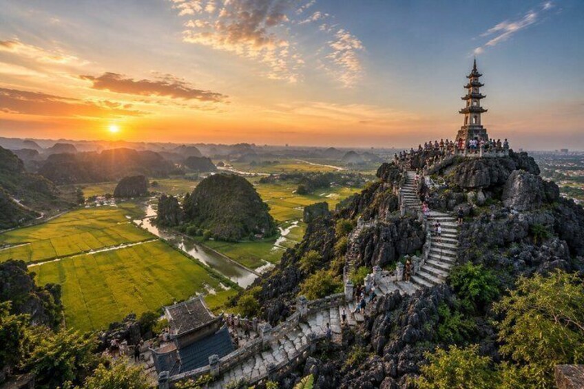 A pagoda on a mountain with a river and fields below. 1