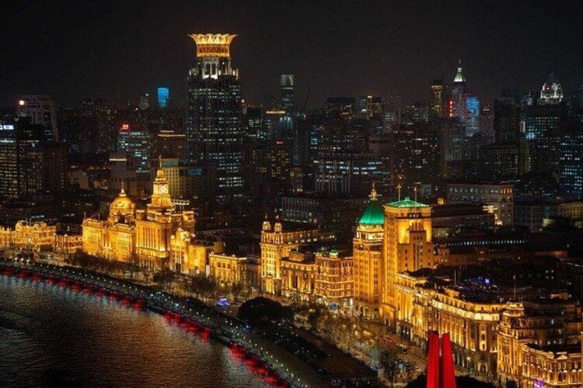 A cityscape at night with illuminated buildings and a river. 2