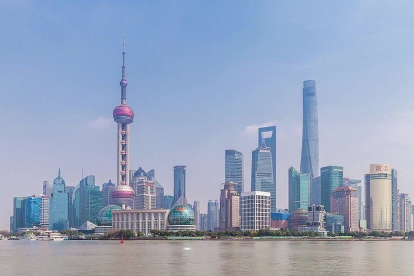 A city skyline with prominent skyscrapers, including a tall tower with a spherical observation deck. 1