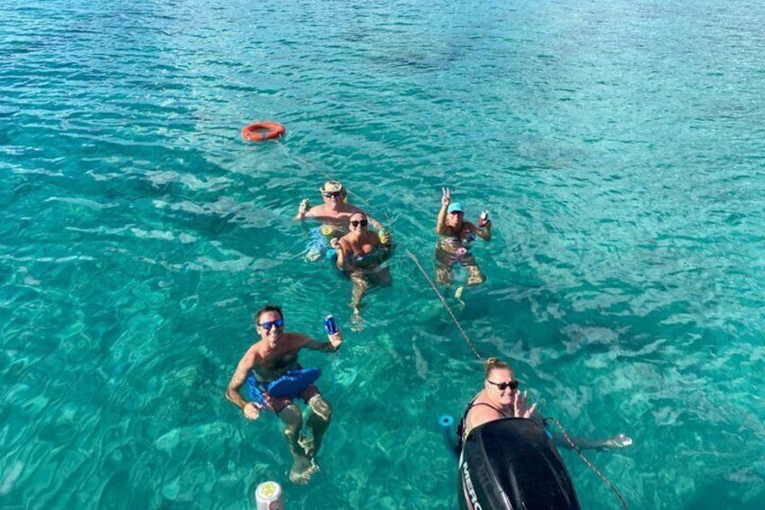 People snorkeling in clear blue water. 5