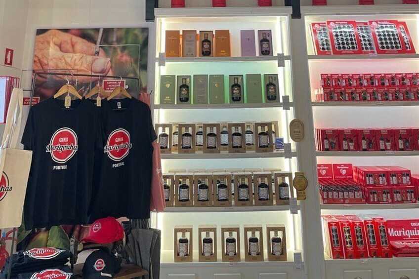 A display of t-shirts, bottles, and boxes in a store. 3