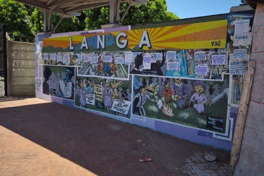 A mural with the word 'LANG' and various messages, including one about abortion. 1