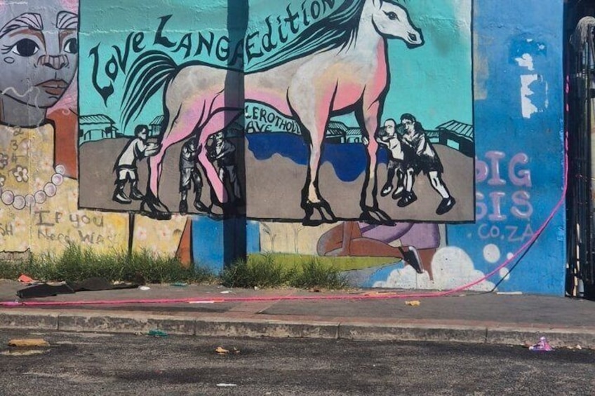 A colorful mural with a horse and children, and the text 'Love Language Edition.' 2