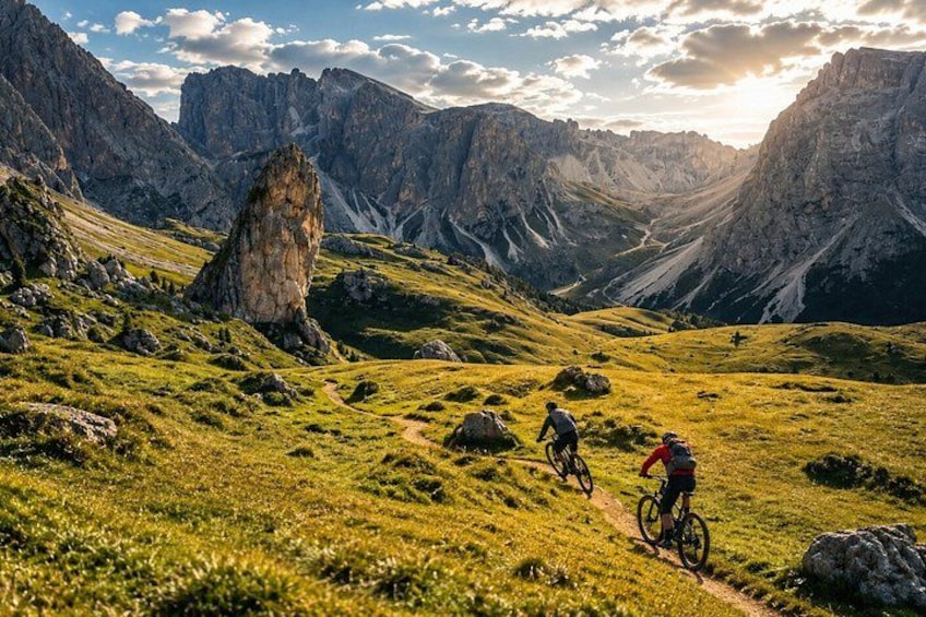 A mountainous landscape with a rocky outcrop and a dirt path. 1