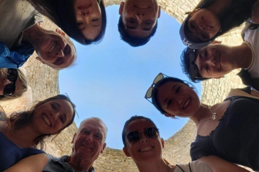 A group of people standing in a circle, looking up at the sky. 1