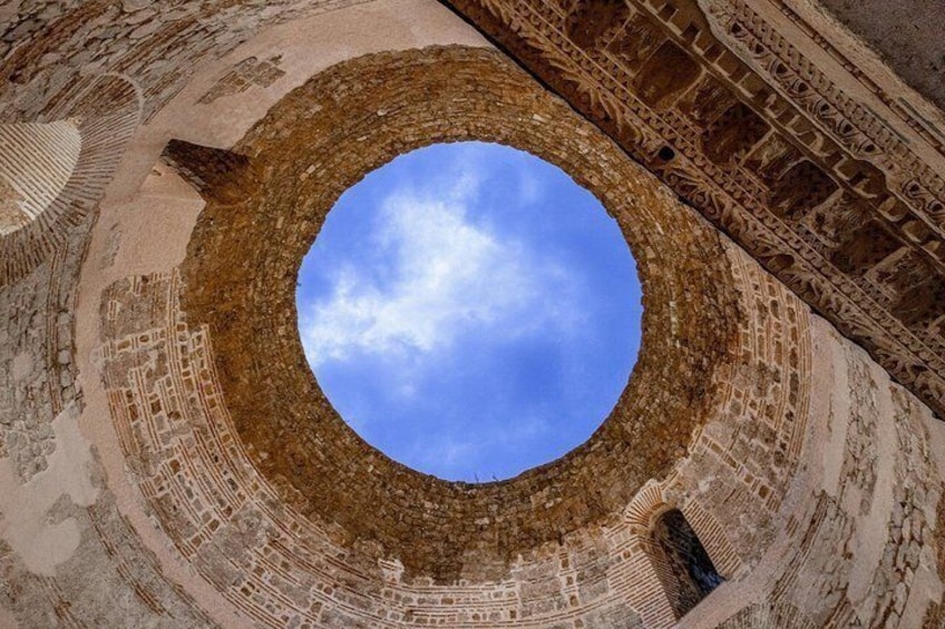 A circular architectural feature with a clear sky visible through the center. 3