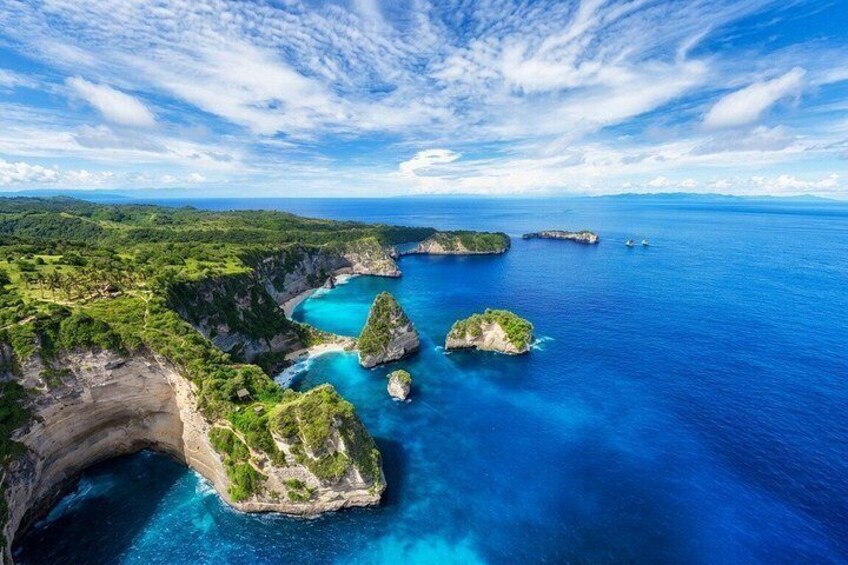 A coastal landscape with cliffs, a bay, and small islands. 1