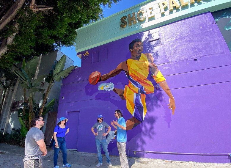 A purple wall with a basketball player in mid-action and a sign reading 'SHOPPA.' 5