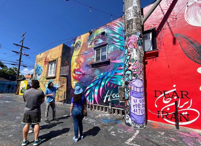 A colorful mural on a building with a large eye design and the word 'Hype' visible. 1