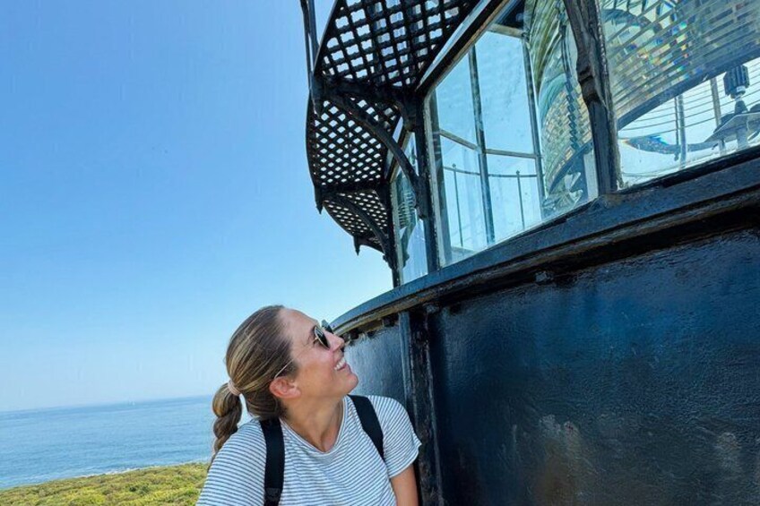 A person standing by a building with a view of the ocean. 2