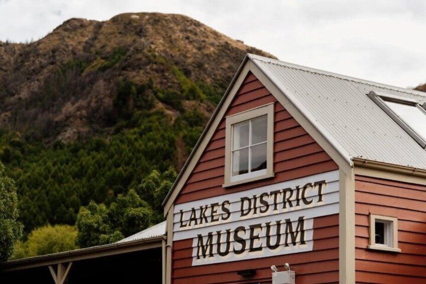A red building with a sign that reads 'Lakes District Museum.' 4