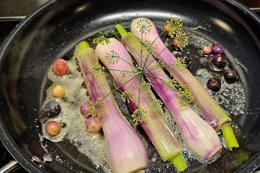 Leeks being fried in a pan with oil. 3