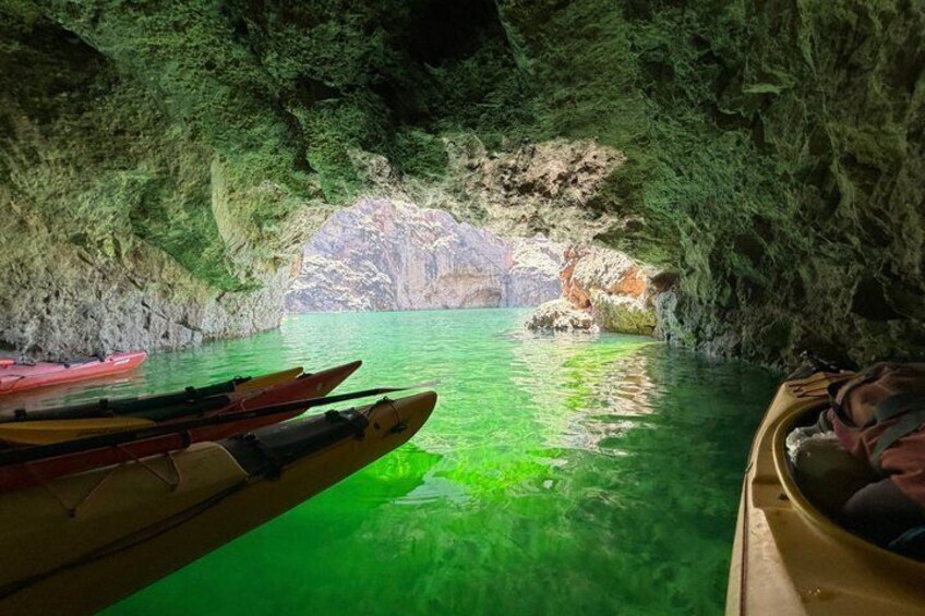 A cave entrance with kayaks inside. 4