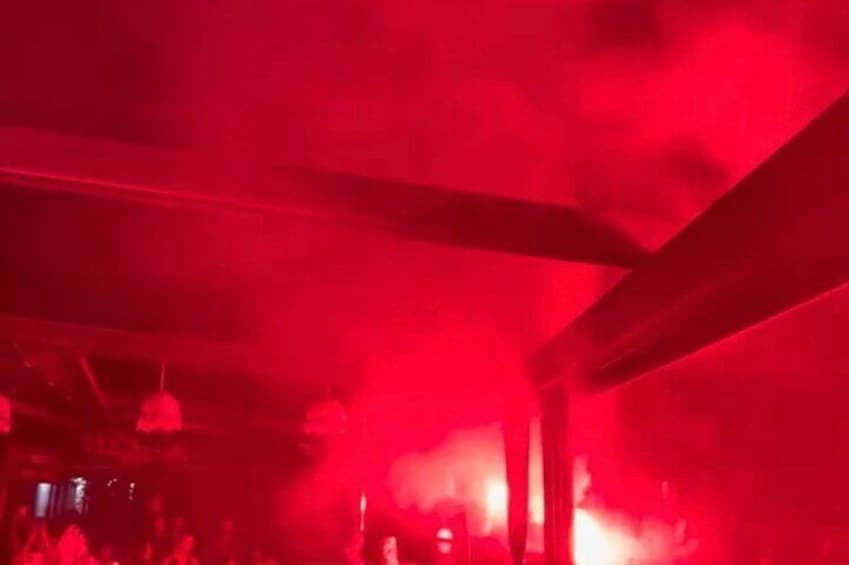 A red-lit interior with visible beams and smoke. 4