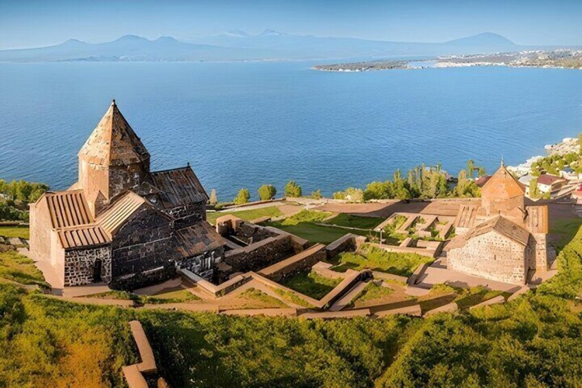 An ancient fortress with a prominent tower, surrounded by lush greenery and a body of water in the background. 3