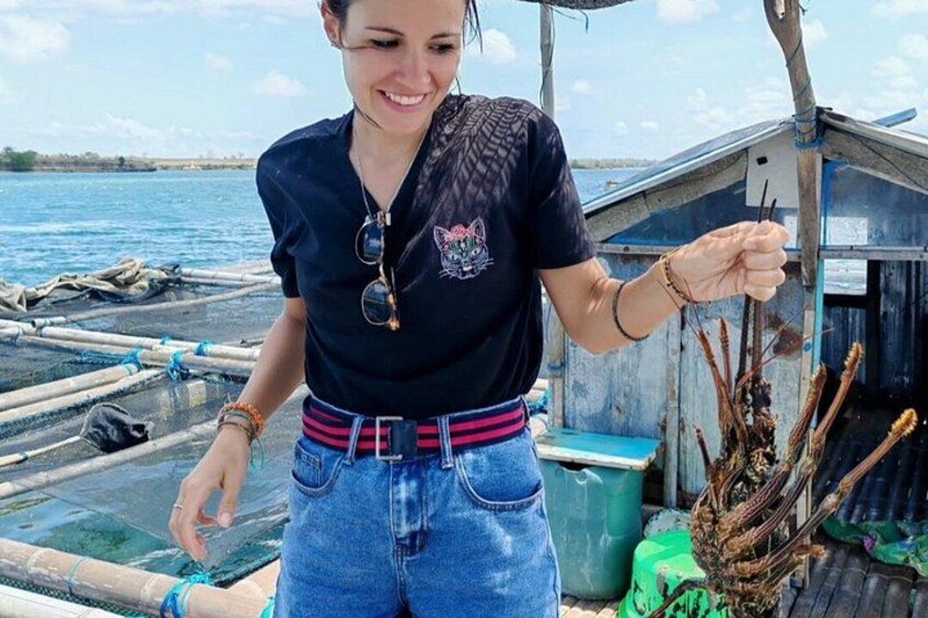 A person on a boat holding a fishing net. 3