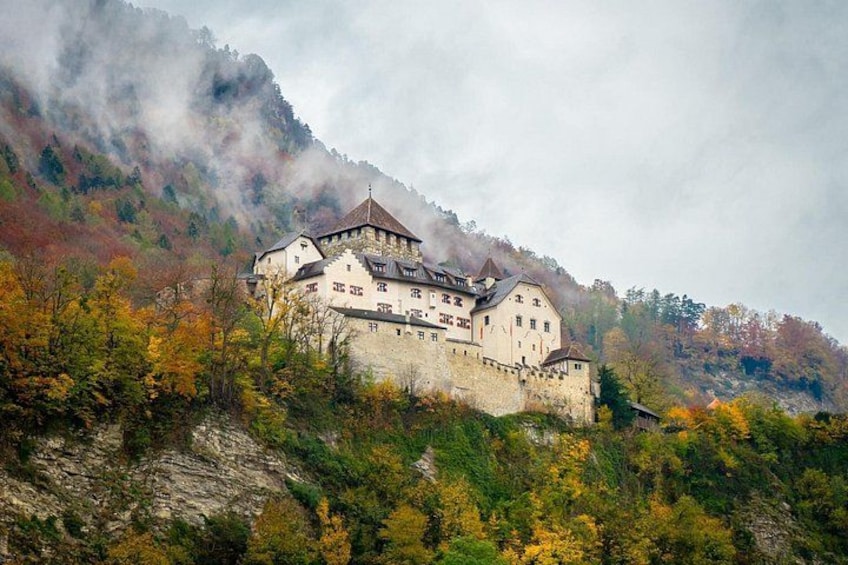 A castle on a hill with autumn foliage. 2