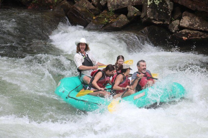 A group of people rafting down a river. 4