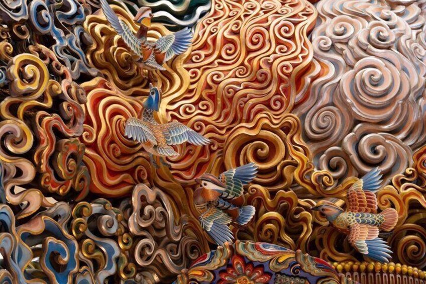 A detailed mural with swirling patterns and stylized birds. 1