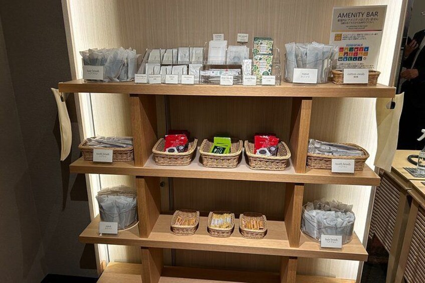 A wooden shelf with various packaged goods and baskets. 2