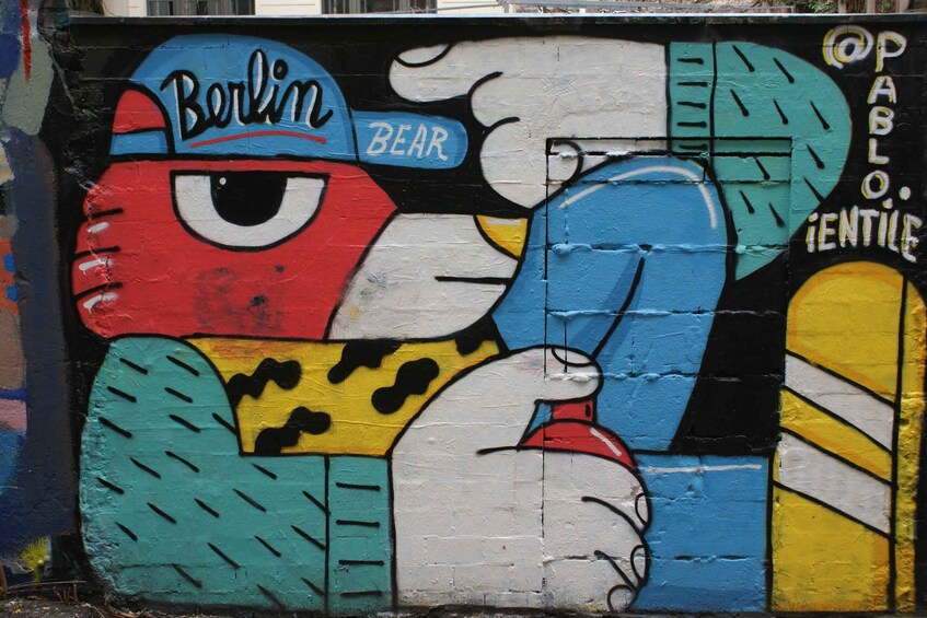 A colorful mural with the words 'Berlin' and 'BEAR' on a wall. 1