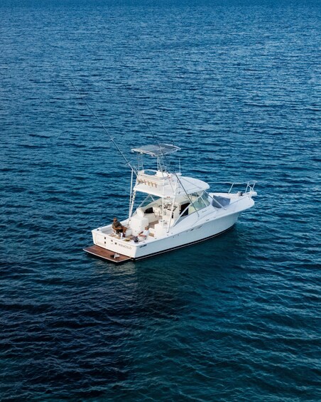A white yacht named MIRACULO on calm blue waters. 2