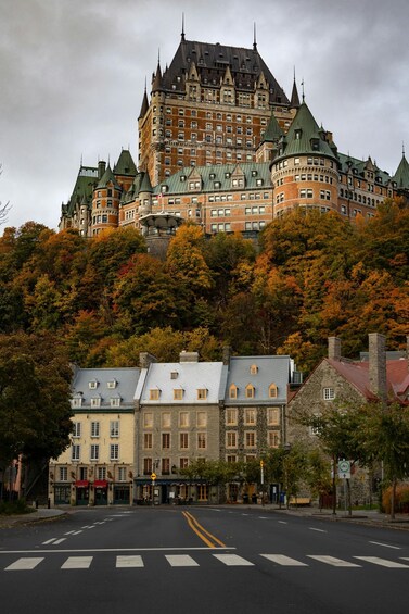A historic building with a castle-like structure, surrounded by autumn foliage. 2