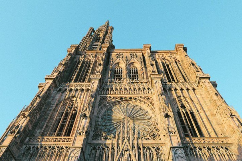 A Gothic cathedral with intricate stone carvings and a large rose window. 1