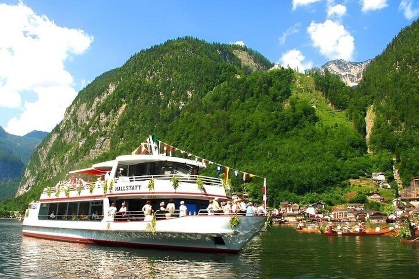 A boat named 'Hallstatt' on a lake surrounded by mountains. 5