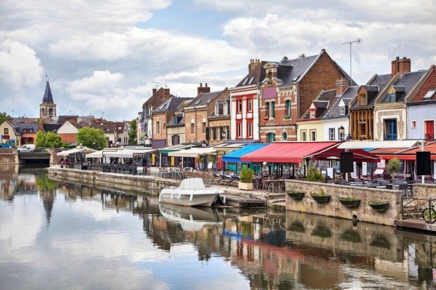 A canal with buildings and a boat. 4