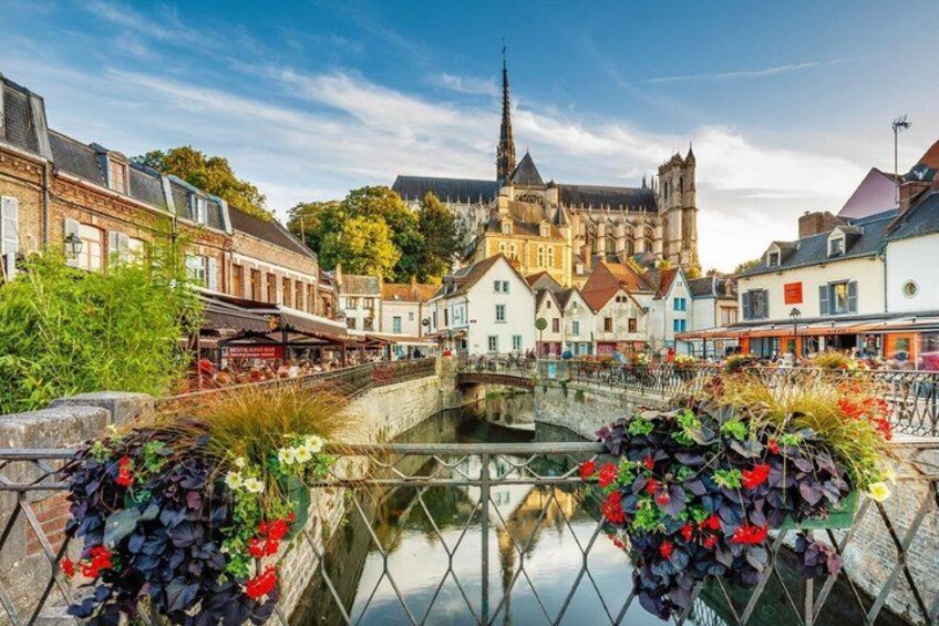 A canal with buildings and a church in the background. 5