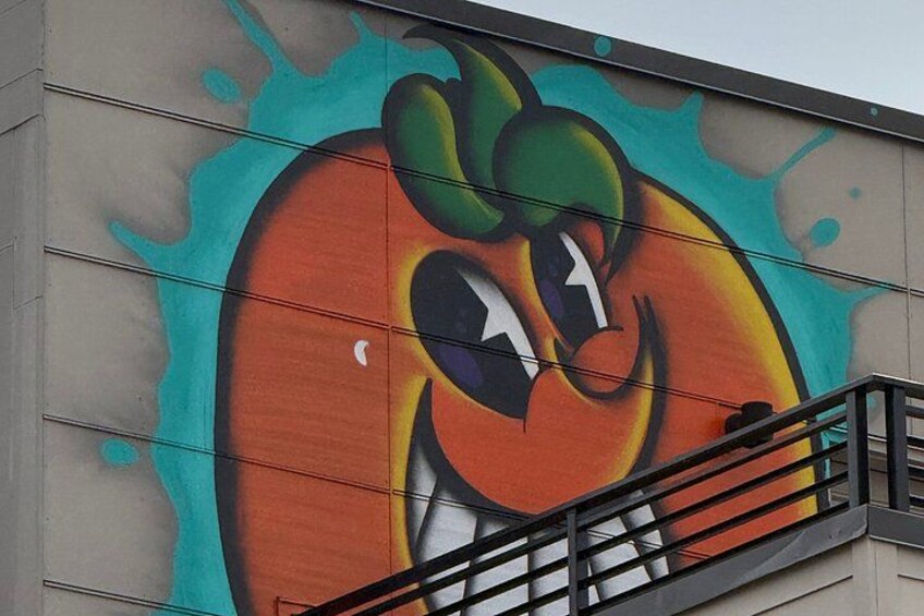 A mural of a stylized fruit on a building wall. 2