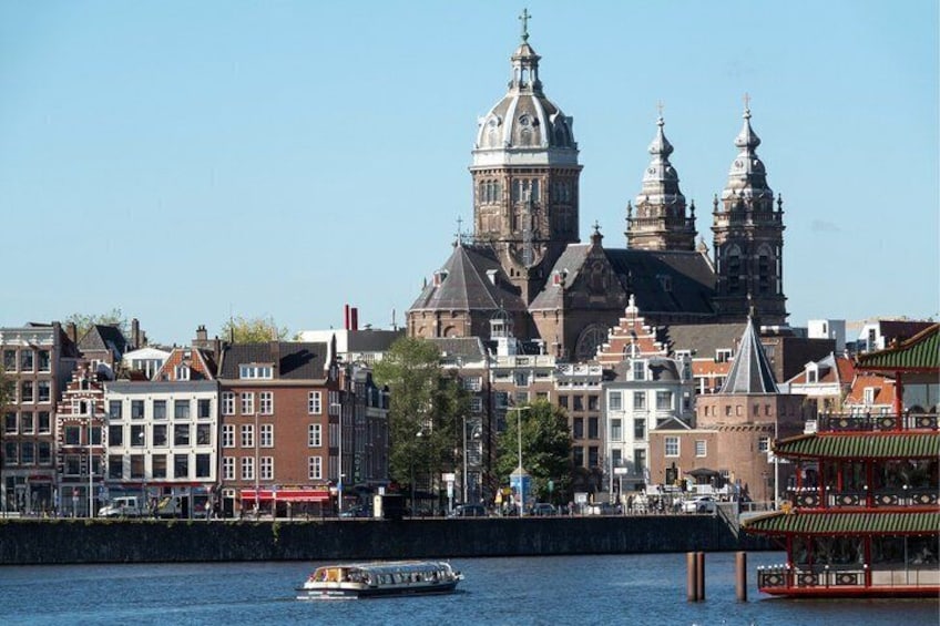 A historic cityscape with a prominent church and a canal. 4