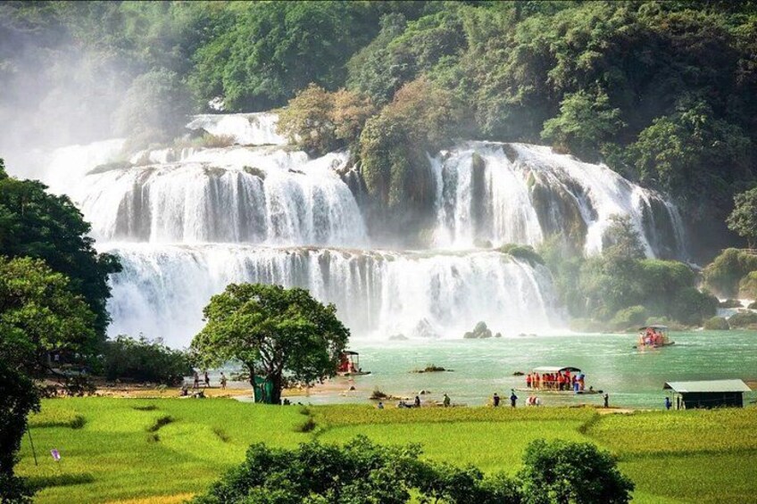 A waterfall, a boat, and a green landscape. 3