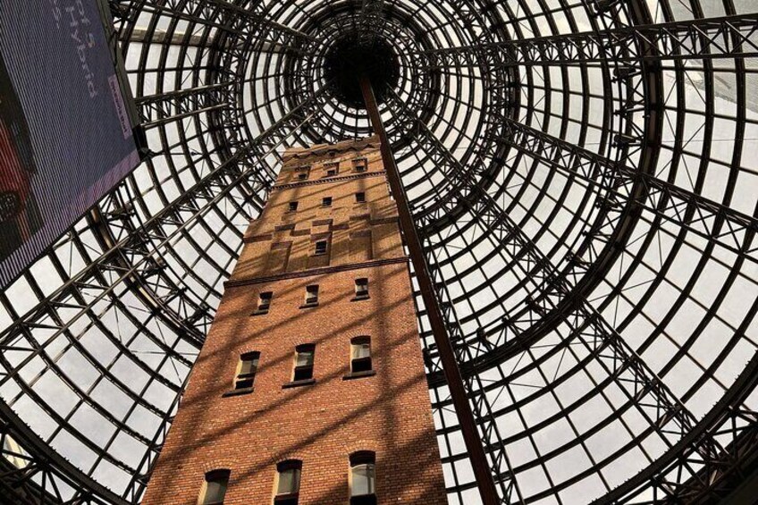 A tall brick building with a circular glass ceiling structure. 2