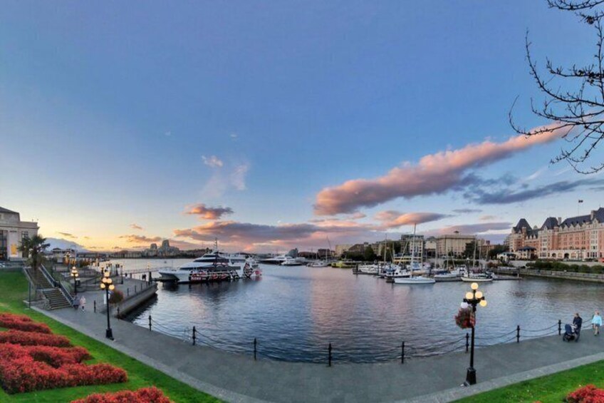 A riverside promenade with boats, a bridge, and buildings along the water. 3