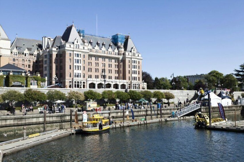 A river with a yellow boat, a bridge, and a large building with a tower. 4