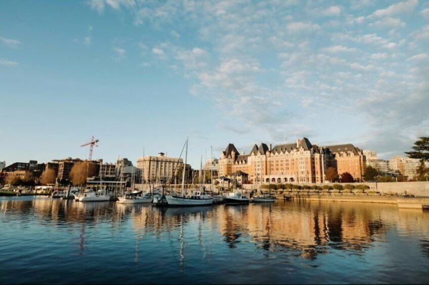 A waterfront with boats, a large building, and a crane. 2