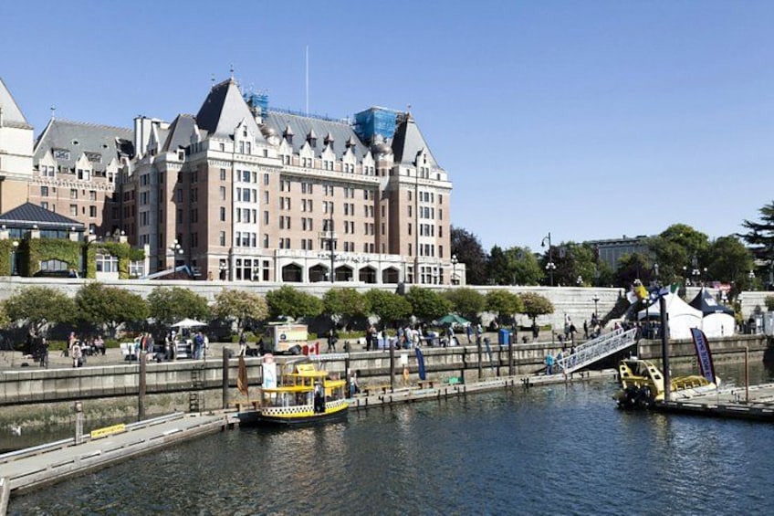 A river with a yellow boat, a bridge, and a large building in the background. 4