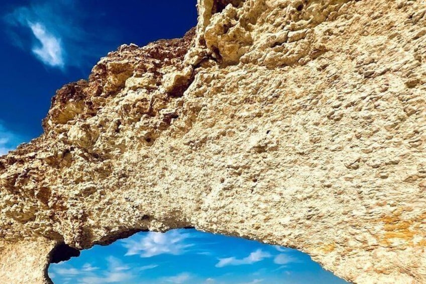 A rock formation with a natural archway. 2