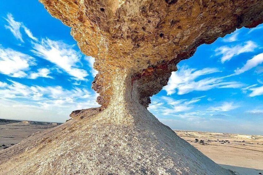 A large rock formation with a cave-like opening. 5