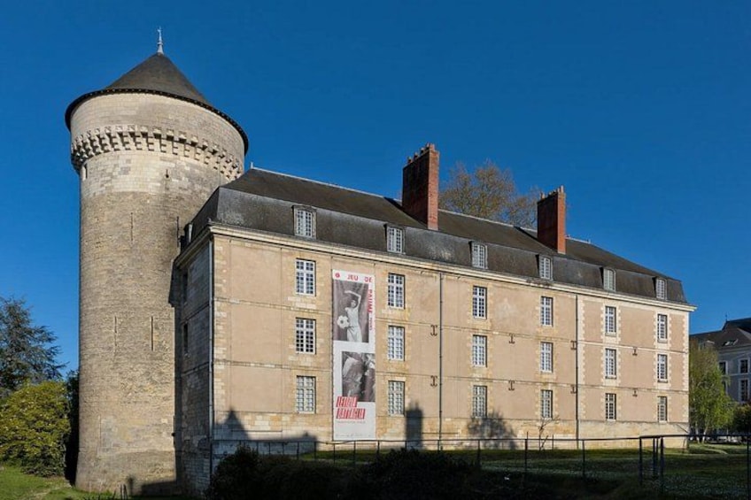 A historic building with a tower and multiple windows. 3
