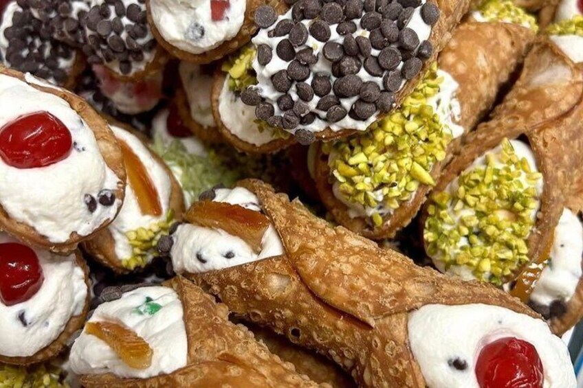 A collection of decorated pastries with toppings like chocolate chips and pistachios. 5