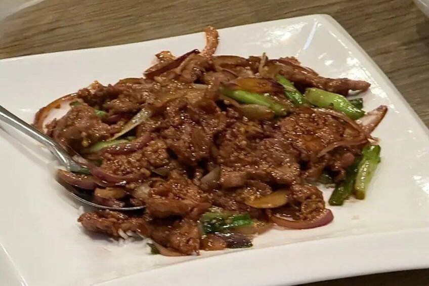 A plate of stir-fried beef with vegetables. 3